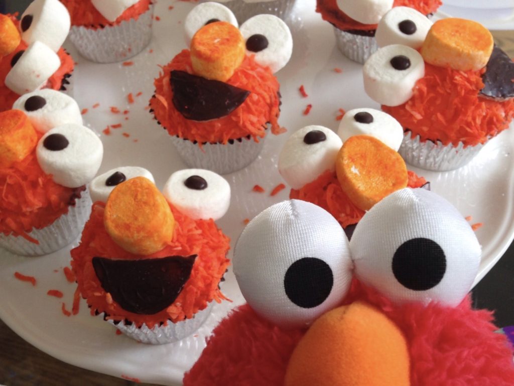 Elmo cupcakes are made with orange coconut "fur" and marshmallow eyes.