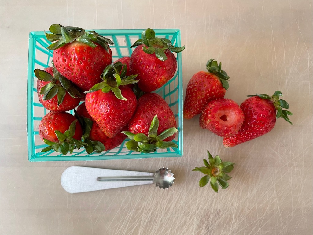 Hull strawberries and select berries of fairly uniform size for the strawberry rolls.