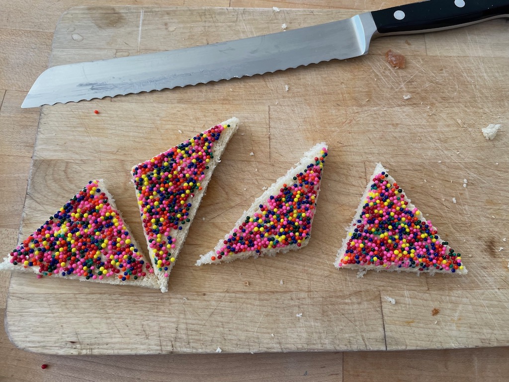 Fairy bread cut in triangles--the traditional way.