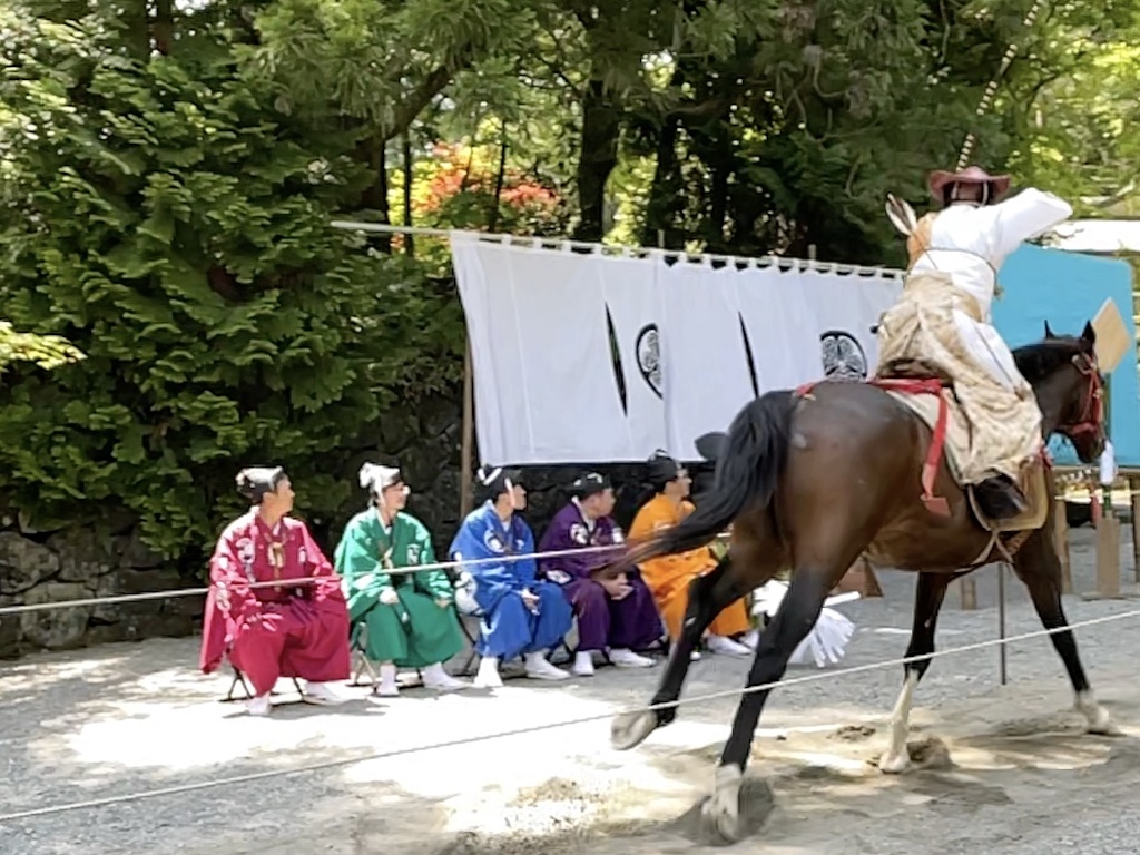 Archer on horseback shoots at a wooden target at a festival in Nikko.