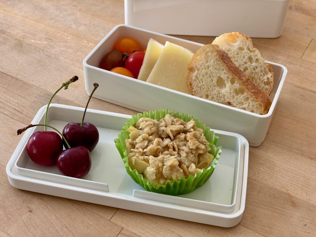 Mini Apple Crisp is set in a bento lunchbox. The recipe makes just four crisps.