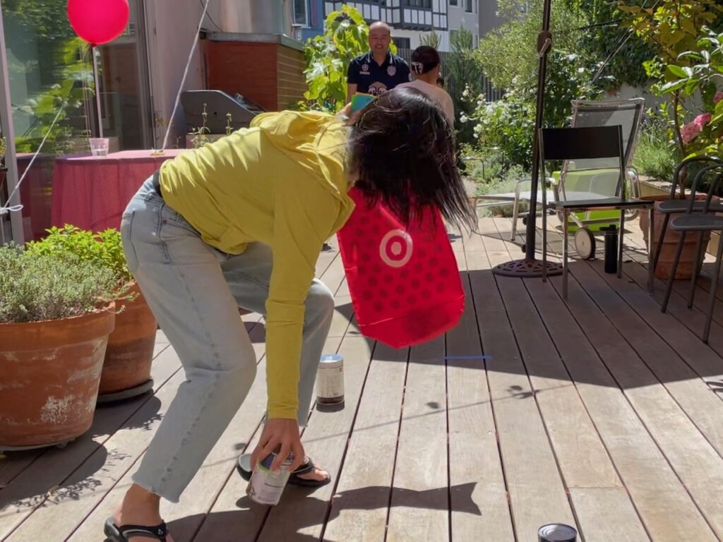 In this relay race, each team gathers grocery store items. The team that gathers all the items first wins.