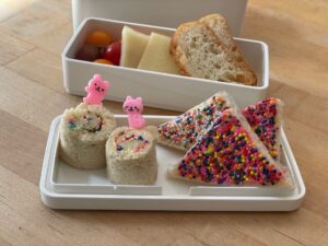 Fairy Bread, as seen in this bento, is made by buttering white bread and topping with sprinkles.