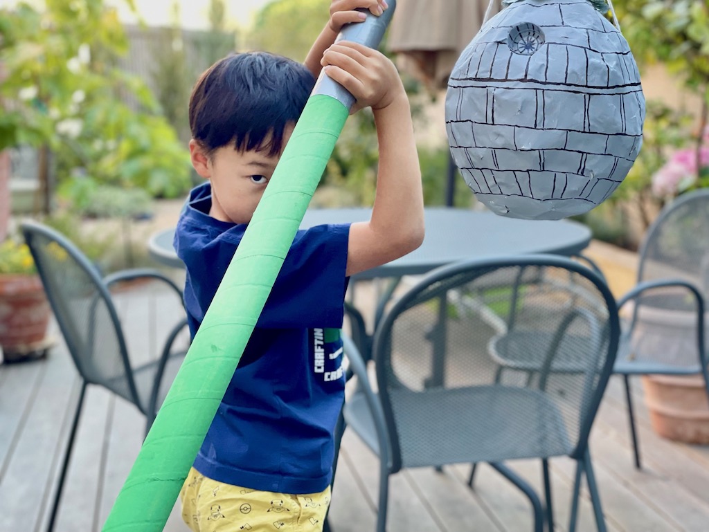 Make a lightsaber that can break a piñata by using a heavy-duty cardboard tube.