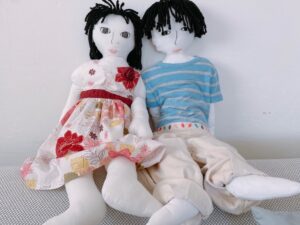 Life-size dolls of a child are wearing the child's clothes.