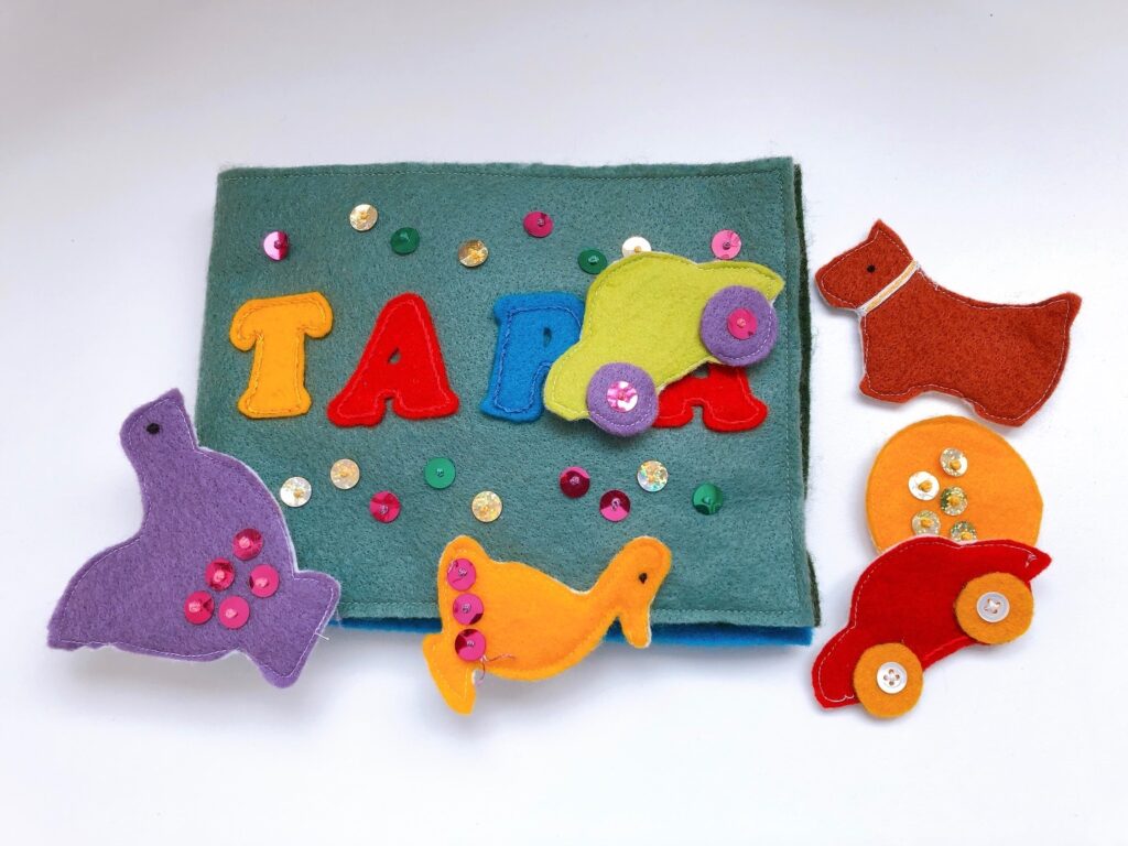 This DIY Christmas gift is a felt book with Velcro-backed felt shapes so they can be placed on the book to tell a story.