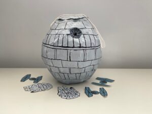 Star Wars Death Star piñata is made with newspaper strips glued to a balloon.