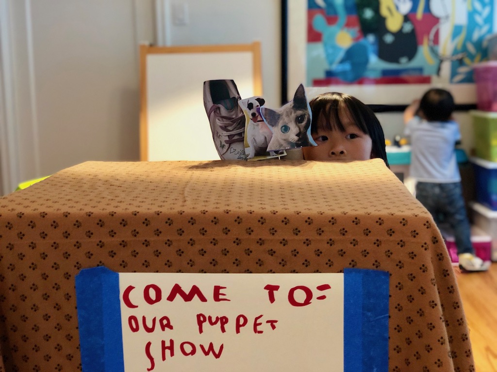 Use a big box covered with a blanket as the stage for a puppet theater.