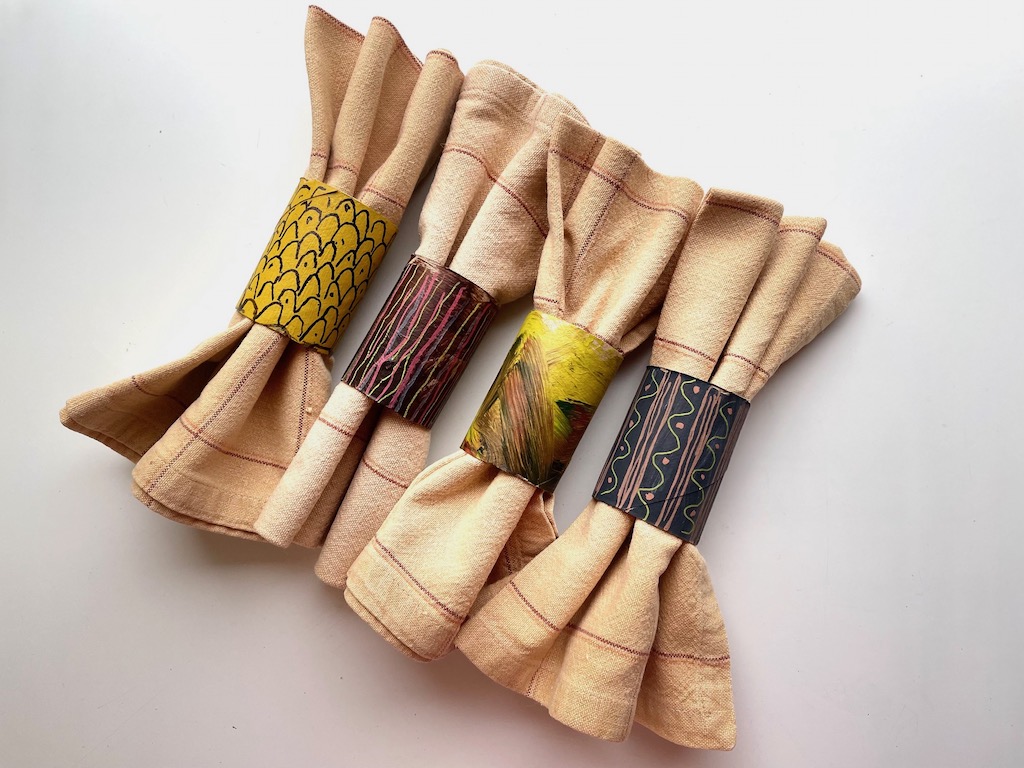 Kids can paint segments of cardboard gift wrap rolls in fall colors to use as napkin rings for the Thanksgiving table.