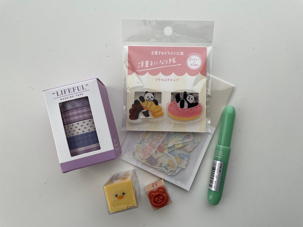 A few Advent calendar "stuffers" found in Japan including animal paper clips, stickers, pen, stamp, eraser, and washi tape.