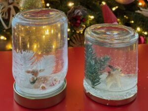 Snow globes are made with small jars, plastic decorations, glycerin, and glitter.