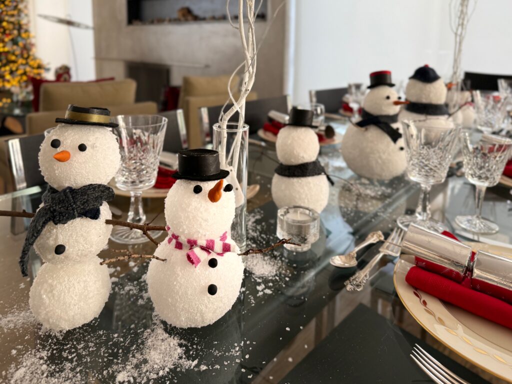 Snowmen centerpieces line the table for Christmas Eve dinner.