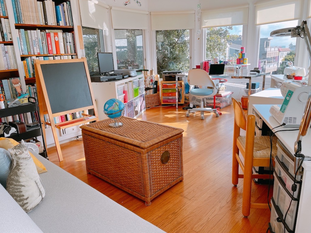 A craft room equipped with bins to stash craft tools and materials.