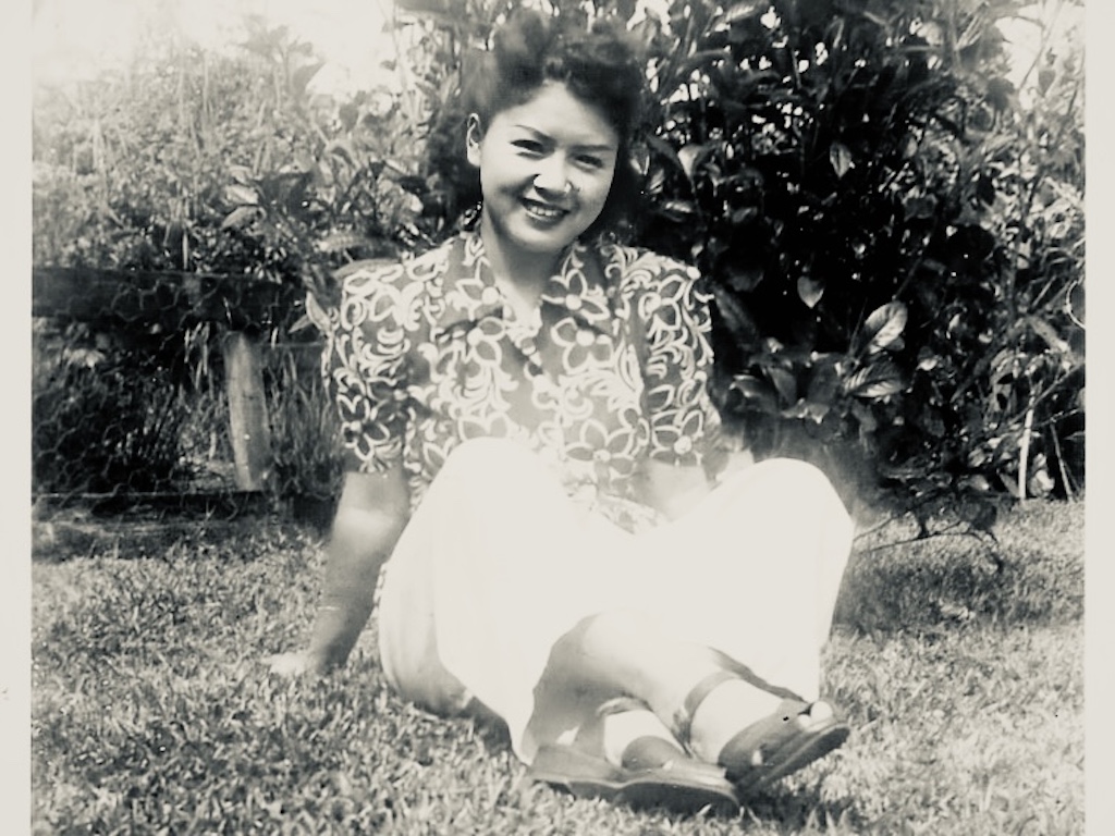 A photograph of the birthday honoree, celebrated as a grandma, in her 20s.