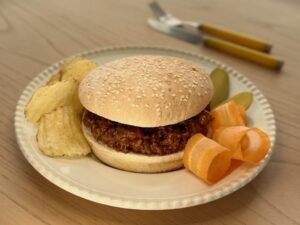 Sloppy Joes features ground beef in a sweet and tangy sauce, served on toasted buns.