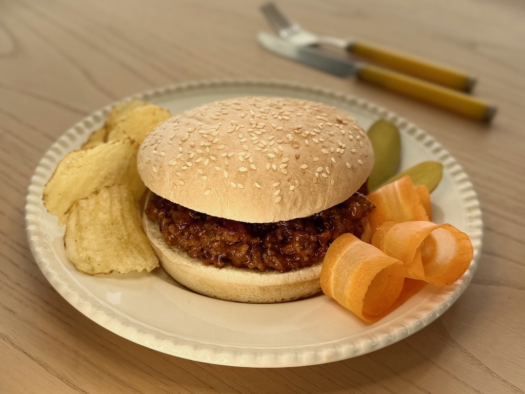 Sloppy Joes are made with ground beef seasoned with ketchup and mustard for sweet and tangy flavor.