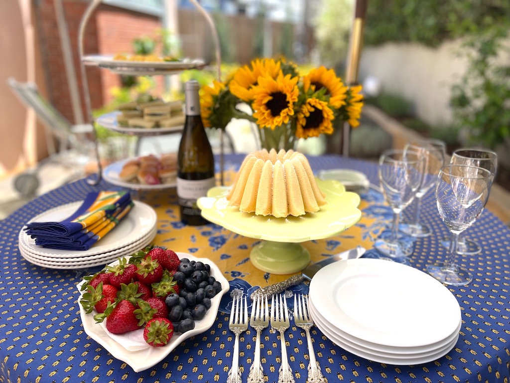 Table is set for a small party for a few friends. On the menu: tea sandwiches, wine, berries and a poundcake. This is one way to socialize and connect, which is one of the habits of people who age well.