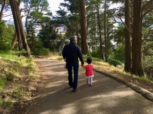 Grandparent and grandchild out for a walk. It's a good time for conversatiion.