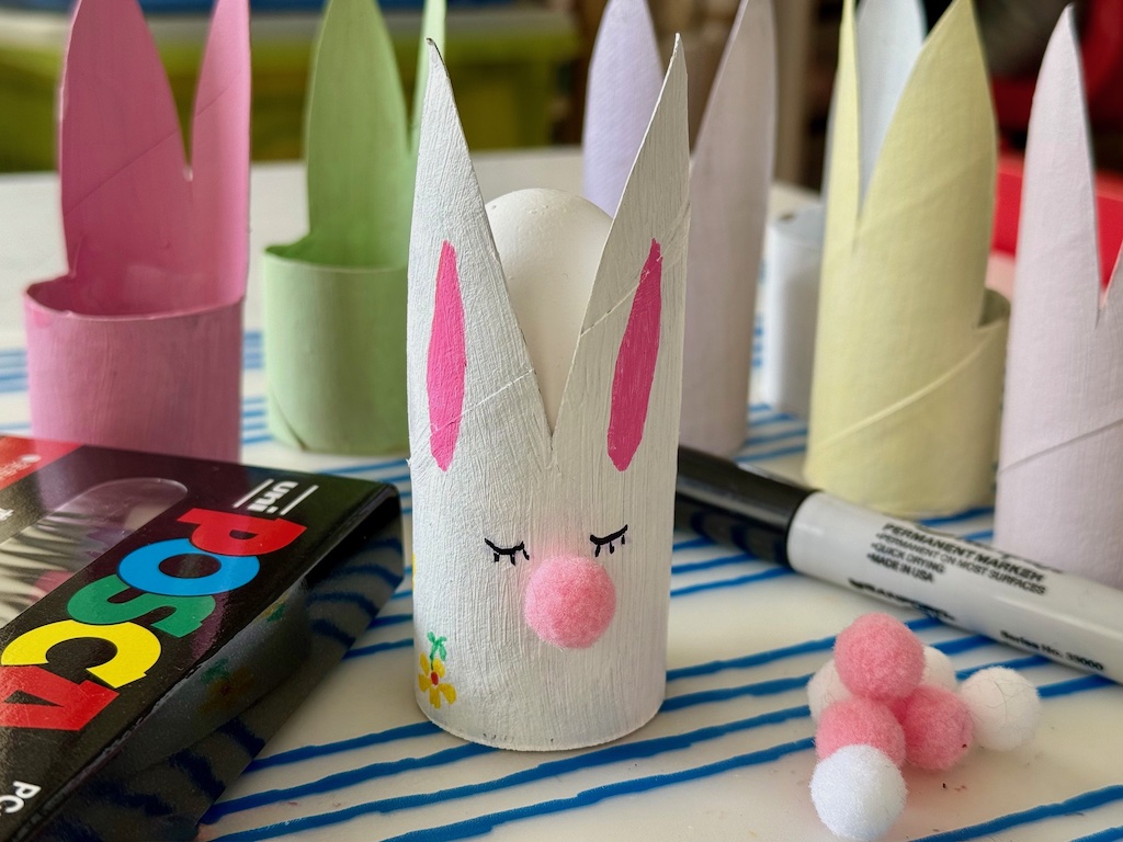 Prototype of toilet roll Easter bunny has been painted and decorated. Egg sits in the back of the bunny.