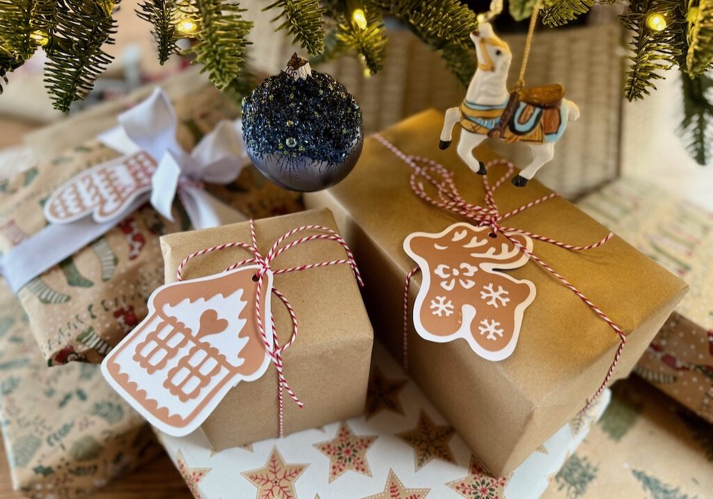 Kids' Christmas presents to parents wrapped and under the Christmas tree.