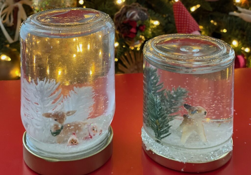 Snow globes are made with small jars, plastic decorations, glycerin, and glitter.